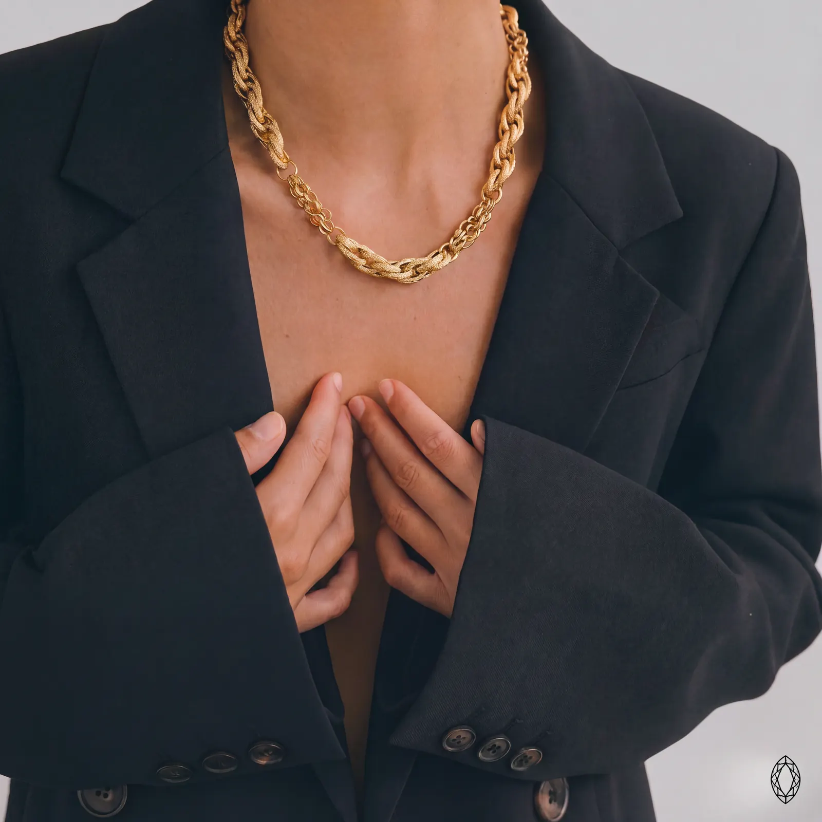 AI jewelry photoshoot: chunky gold chain with black blazer